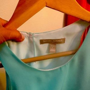 Sleeveless top with a light pastel blue first layer and a white lining.